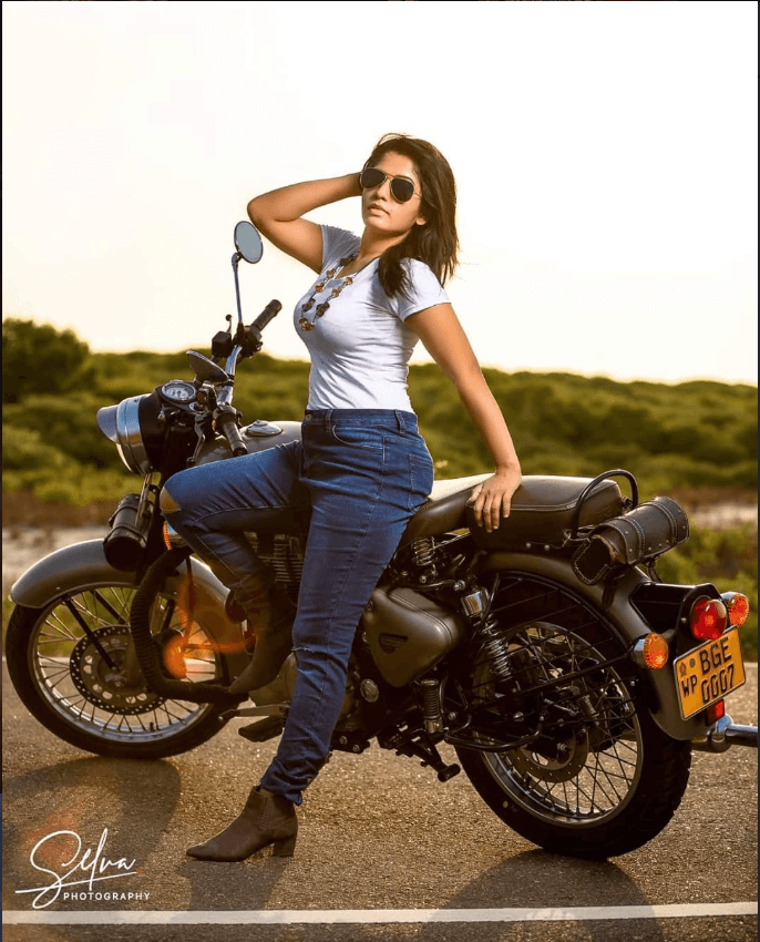 Outdoor fashion portrait beside a motorcycle
