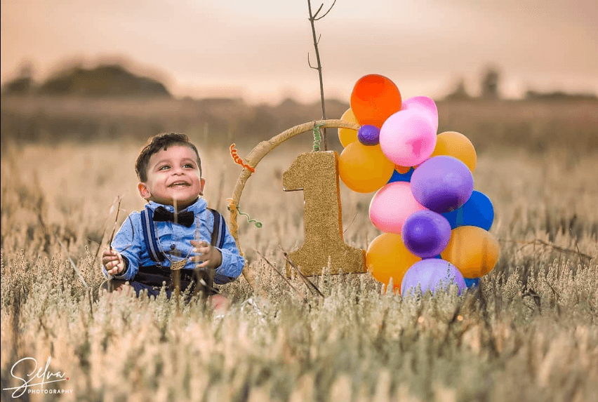 Family birthday portrait outdoors — editorial placeholder